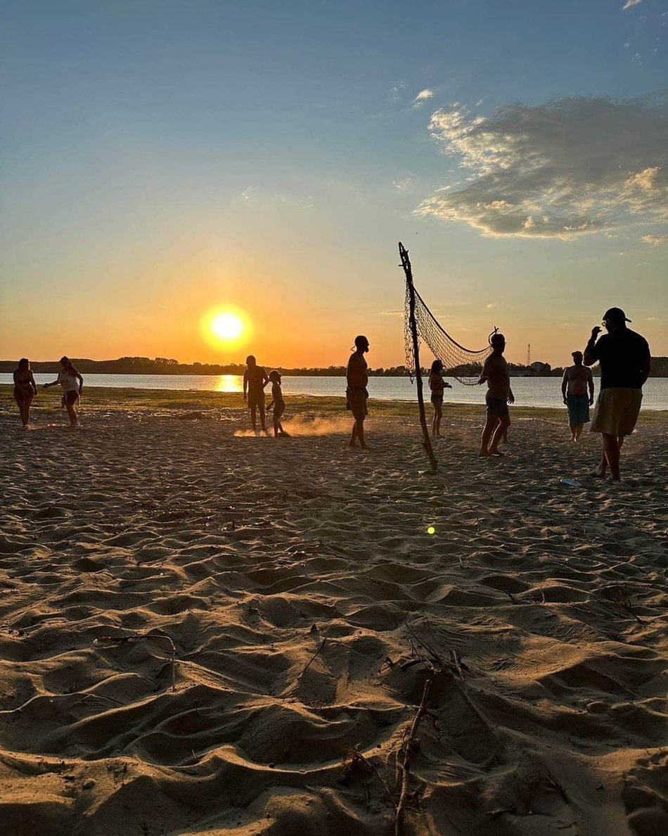 Beach football at sunset